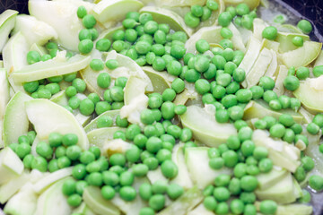 Stewed zucchini with peas . Tasty meal for vegetarians