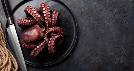 Tasty octopus on black background © evgeeenius