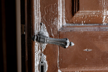 old brown church door with iron doorknob