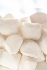 Fototapeta na wymiar A stack of marshmallows on a white background.