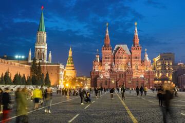 Fototapeta premium Sights of Moscow. Kremlin in Russia. Red Square with people. Moscow Kremlin at night. Russia on background of night sky. Panorama of Moscow. Kremlin walls. Rest in Russia. Tour to Russian Federation.