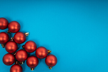 Red christmas balls on blue background. Christmas holiday celebration concept