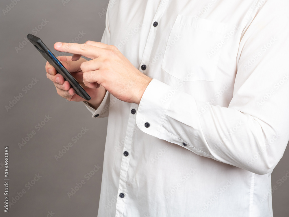 Poster hands of man with phone. businessman with cellphone. he dials message or number. man in shirt holds 