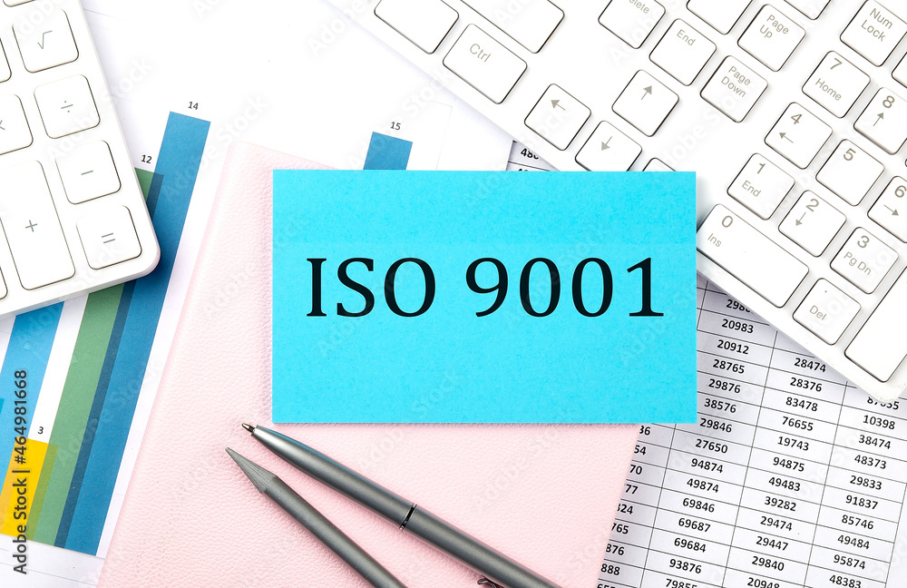 Poster iso 9001 text on blue sticker on chart with calculator and keyboard