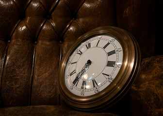 Big vintage wall clock in a chester sofa