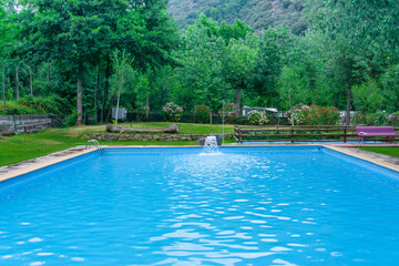 Pool with artificial waterfall in a mountain campsite in Lleida