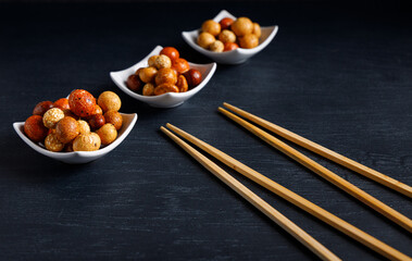 Senbei japanese snack. Senbei traditional Japanese snack in a bowl close-up. Rice crackers with nori, peanuts with sesame seeds, and other snacks. Mix traditional Japanese snack food.