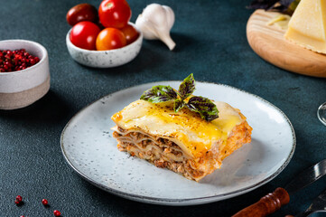 Piece of tasty hot lasagna on light background. Traditional italian lasagna. Italian food. Close up lasagna. Bolognese sauce. Bechamel sauce. Still life of food. Homemade meat lasagna.