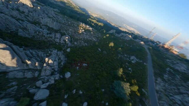 FPV video, mountain surfing, flying at high speed over a granitic mountain range during a beautiful sunrise. Mount Limbara (Monte Limbara) Tempio Pausania, Sardinia, Italy.
