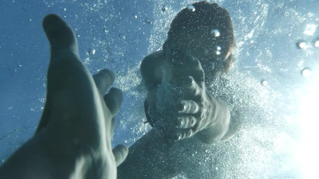 Emotional Female Savior Saving Drowning Man Underwater Shooting. Woman Rescuer. Hope Concept