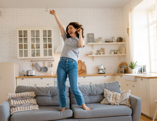 woman jumping on the sofa