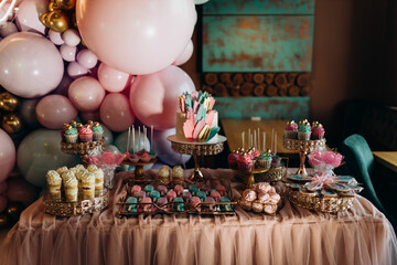 girls birthday decoration on table delicious pink cupcakes and birthday cake
