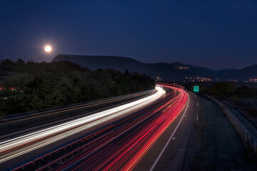 Fototapeta na wymiar Dramatic motorway car light trails at night