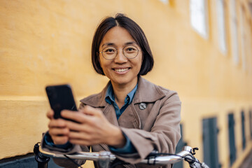 Portrait of a mature asian businesswoman on a bicycle.