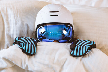 woman sleeping in bed in ski equipment