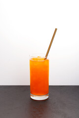 Crushed ice with red orange flavor. Orange granizado in tall glass. Vertical orientation, selective focus, copy space