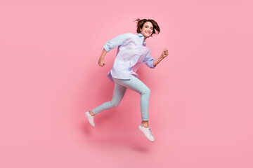 Fototapeta na wymiar Full length body size photo woman smiling jumping up running on sale isolated pastel pink color background