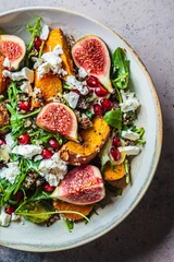 Foto auf Alu-Dibond Warm autumn quinoa salad with baked vegetables, figs, feta cheese and pomegranate. © vaaseenaa