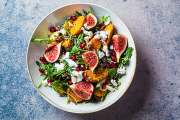 Warm autumn quinoa salad with baked vegetables, figs, feta cheese and pomegranate.