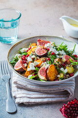 Warm autumn quinoa salad with baked vegetables, figs, feta cheese and pomegranate.