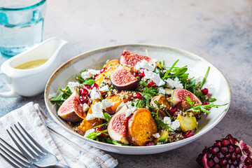 Warm autumn quinoa salad with baked vegetables, figs, feta cheese and pomegranate.