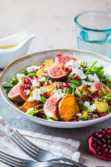 Warm autumn quinoa salad with baked vegetables, figs, feta cheese and pomegranate.