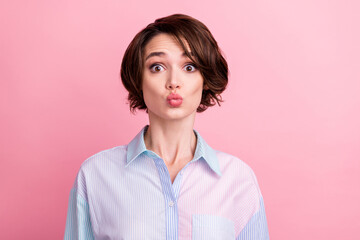 Fototapeta premium Photo portrait amazed woman sending air kiss on date isolated pastel pink color background