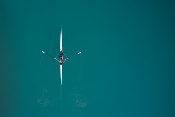 Top view of the rowing race. Aerial view of rowing. White boat for rowing with a woman in motion...