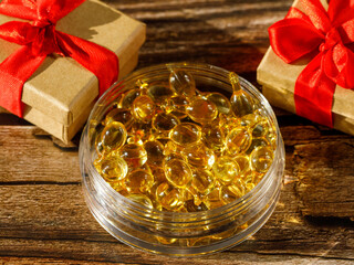 Yellow omega 3, flax seed oil, fish oil, vitamin d or e soft gel cosmetic capsule in container on...