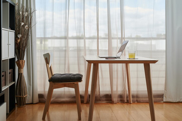 Interior of workroom with laptop on table