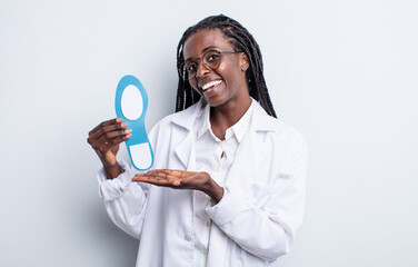 pretty black woman smiling cheerfully, feeling happy and showing a concept. podiatrist concept - obrazy, fototapety, plakaty