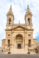 Fototapeta na wymiar View at the Church of Saint Cosma and Saint Damian in the streets of Alberobello - Italy
