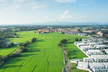 Land and housing estate in aerial view. May call residential building, village, community. Real...