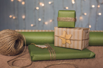 Christmas gifts in green and brown kravtovoy packaging. Gift wrapping. Christmas shopping