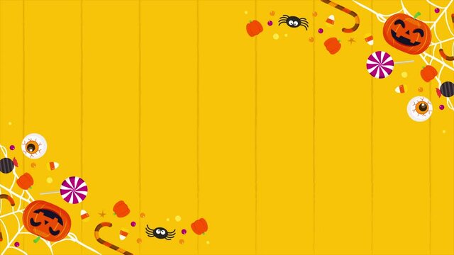 4K Happy Halloween Background Animation. Top view of Halloween candies on orange table background.