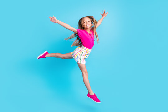 Full body photo of happy cheerful joyful small girl hands wings fly isolated on blue color background