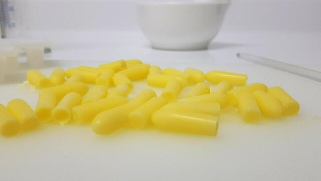 Freshly prepared yellow suppositories in the pharmacy laboratory. Travelling view 