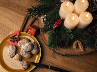 Delicious Christmas stollen on a ceramic plate in front of an Advent wreath and Christmas...
