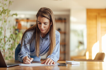 Adult woman, writing down everything she hears.