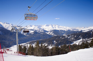 Winter mountains panorama with ski slopes and ski lifts.