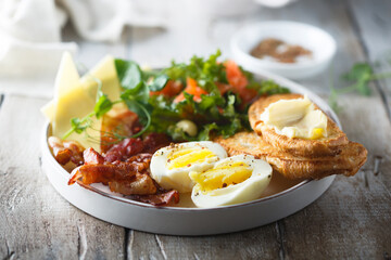 Hard boiled egg, salad and toast for breakfast