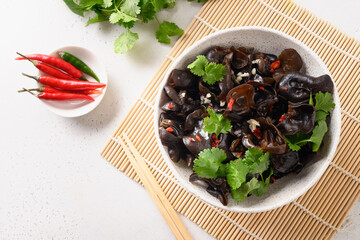 Chinese tree ear black muer mushrooms with chilli pepper and coriander on white background. View from above.