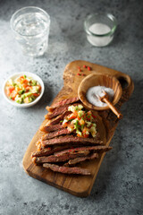 Grilled beef steak with tomato avocado salsa