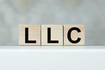 LLC Limited Liability Company text on wooden cubes on the table