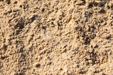 Sand textured background on the beach. Closeup.