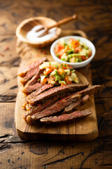 Grilled beef steak with tomato avocado salsa