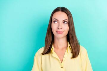 Photo of cool young brunette lady look empty space wear yellow blouse isolated on teal color background