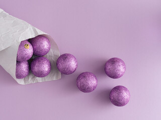 Purple glitter Christmas balls with copy space. Flat lay, top view. Christmas, winter, new year concept.