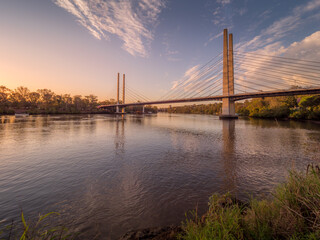 Fototapeta na wymiar River With Bridge in Afternoon Light