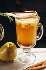 Hot drink cocktail for New Year, Christmas, winter or autumn holidays. Toddy. Mulled pear cider or...